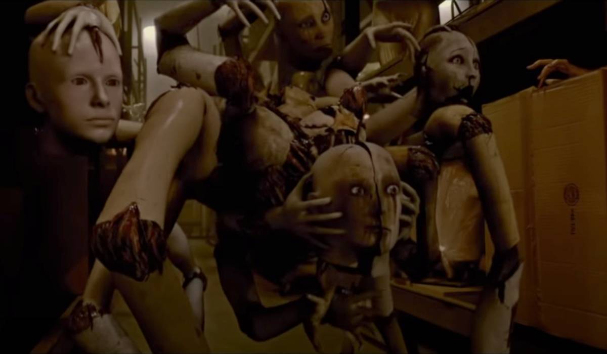 The mannequin spider monster from Silent Hill Revelation in a dark corridor